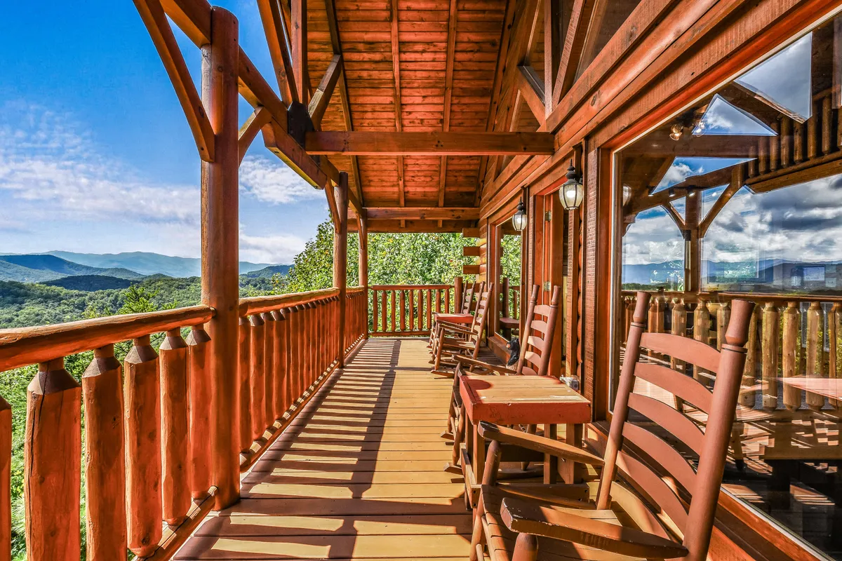 A cozy balcony furnished with classic wooden rocking chairs, offering panoramic views of rolling mountains. The relaxed setting invites guests to savor tranquil mornings, read a book, or stargaze in the evening, enveloped by fresh mountain air.